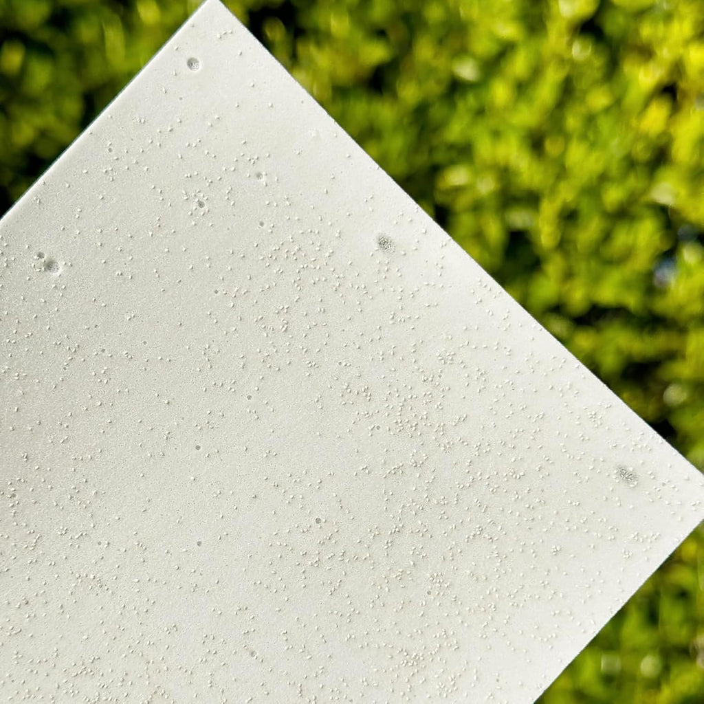 Close-up of visible solid bio-enzyme particles in a Morning Rain laundry sheet