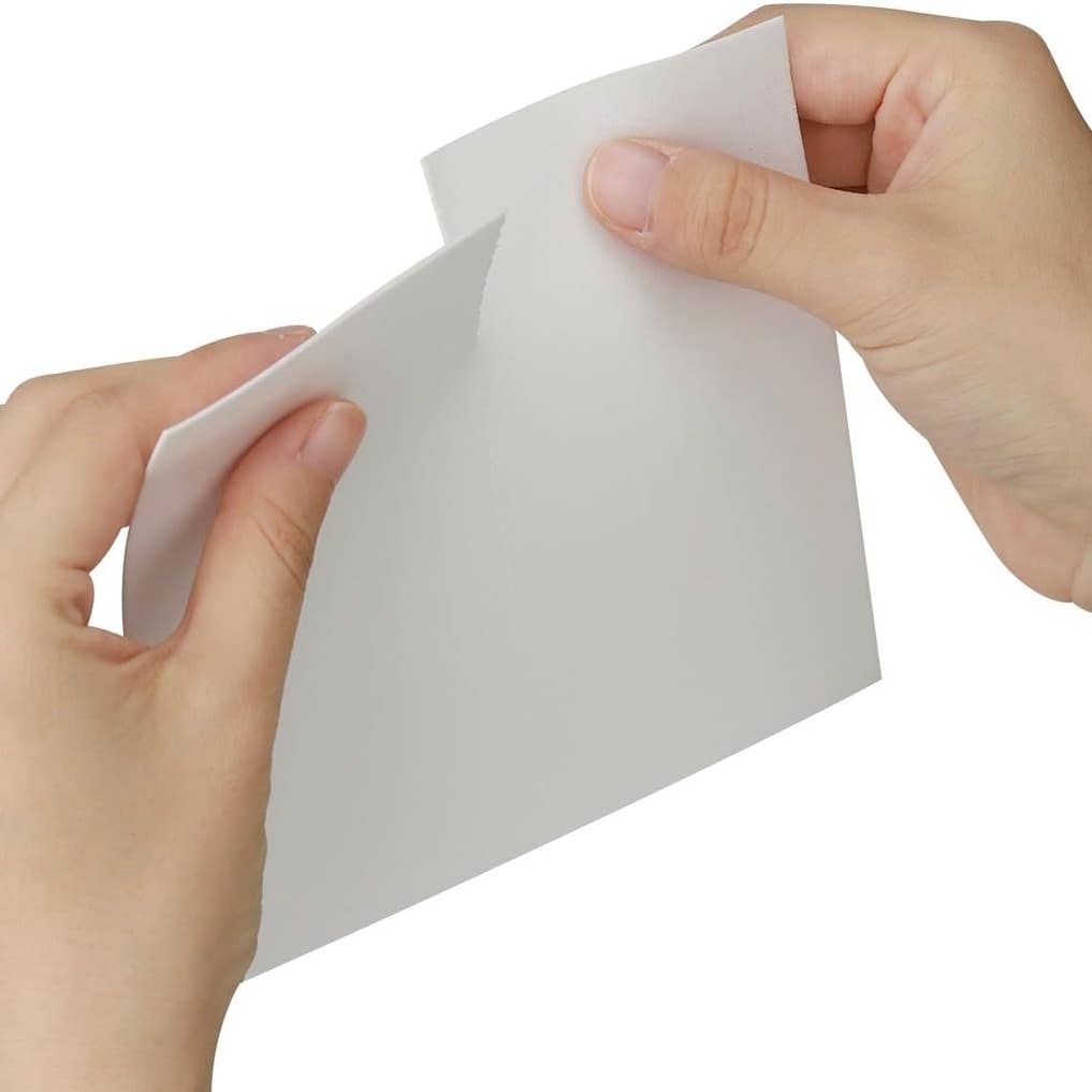 Close-up of a Morning Rain fabric softener sheet being torn for a smaller load